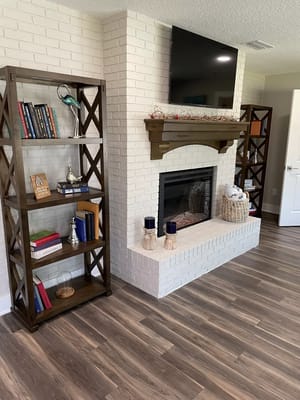 Modern living room with bookshelves and fireplace