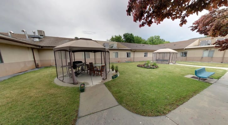 Outdoor patio with seating and shelters at Sandstone Nephi.
