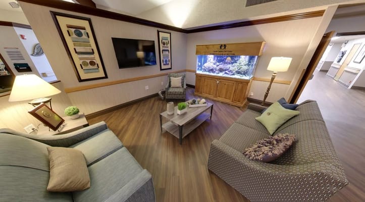 Comfortable common area with seating and aquarium