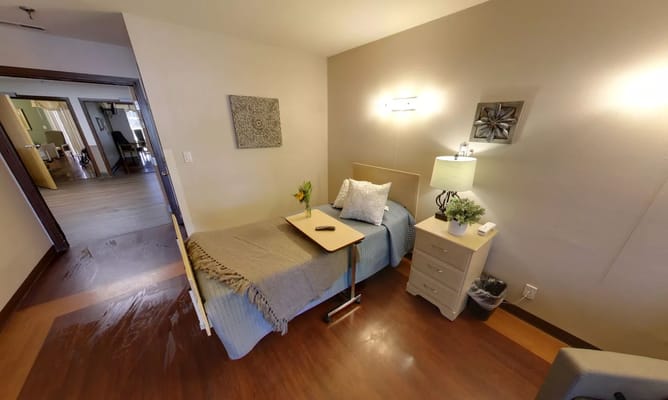 Cozy resident room with a bed and bedside table