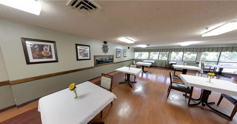 Bright dining area with tables and flowers