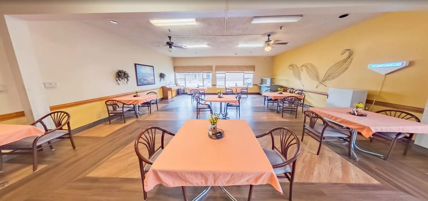 Interior view of the dining area with orange table covers and chairs
