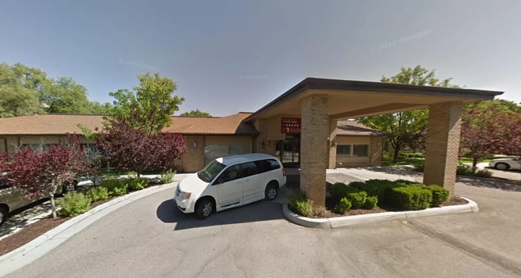 Entrance of Sandstone South Lake with a parked white minivan.