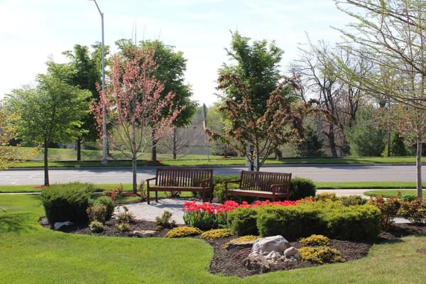 Beautiful outdoor seating area with flowers and trees