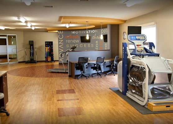 Therapy room with exercise equipment and desks at Sapphire Center.