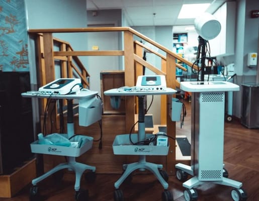 Two therapy equipment carts beside a wooden ramp.
