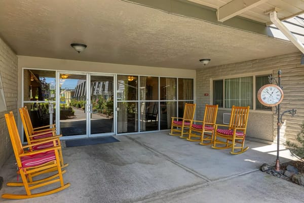Welcoming entrance featuring rocking chairs and clock.