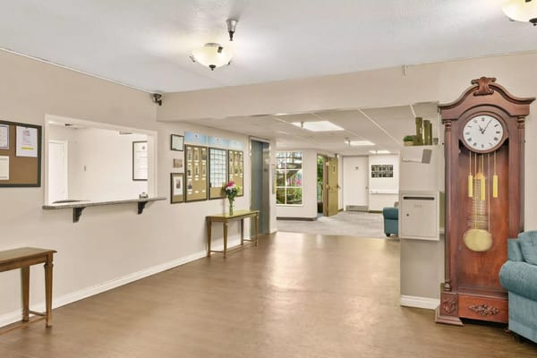 Interior view of the lobby with a clock and floral arrangement