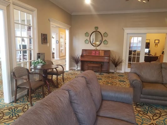 A spacious living room featuring comfortable seating and decorative accents.