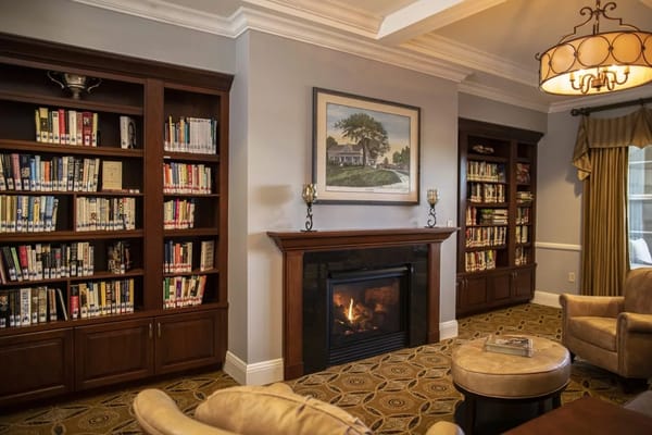 Cozy library area with bookshelves and a fireplace