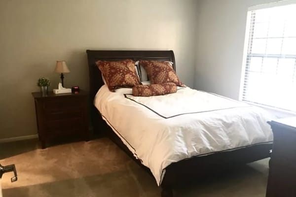 Cozy private room with a bed and decorative pillows