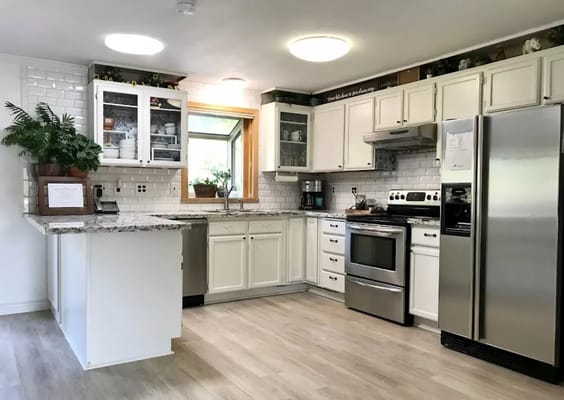 Bright and spacious kitchen area with granite countertops.