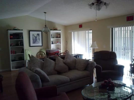 Spacious living room with comfortable seating and decorative shelves