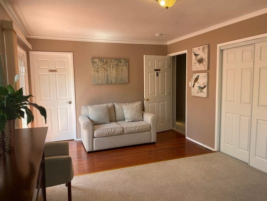 Cozy living room with a white couch and artwork on the walls