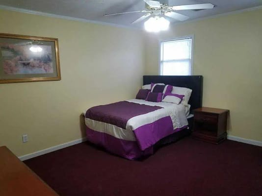 Cozy bedroom with a purple and white bedspread
