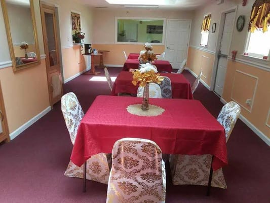 Dining area with red tablecloths and decorations