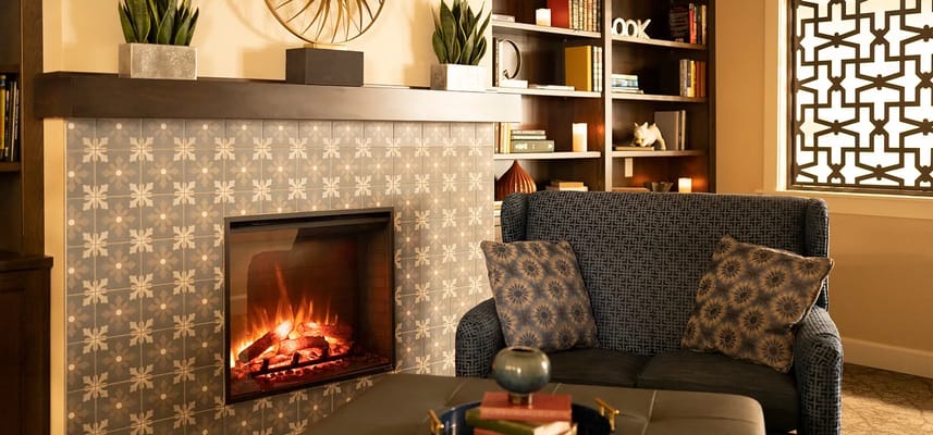 Cozy common area with a fireplace and bookshelves