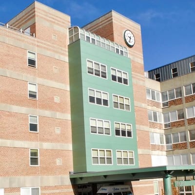 Front view of Sherrill House showcasing the clock tower and green facade