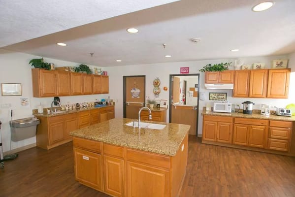 Bright kitchen space with wooden cabinets and granite countertops