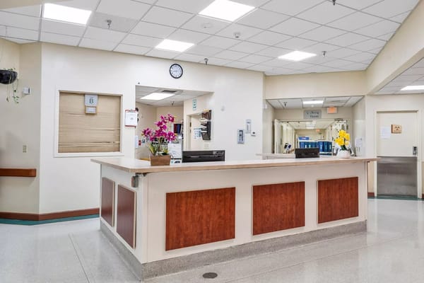 Front desk area with clock and flowers