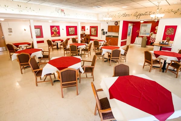 Dining area with red and white table settings