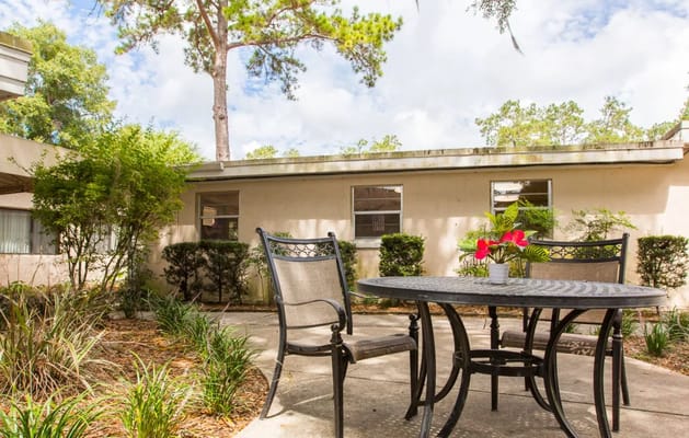 Outdoor seating area with a table and flowers