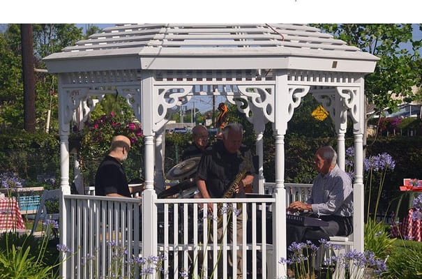 Musicians performing in a gazebo at Silverado Newport Mesa.