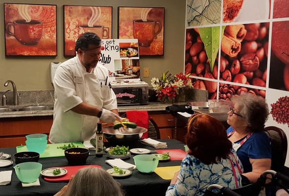 Chef conducting a cooking class for residents.