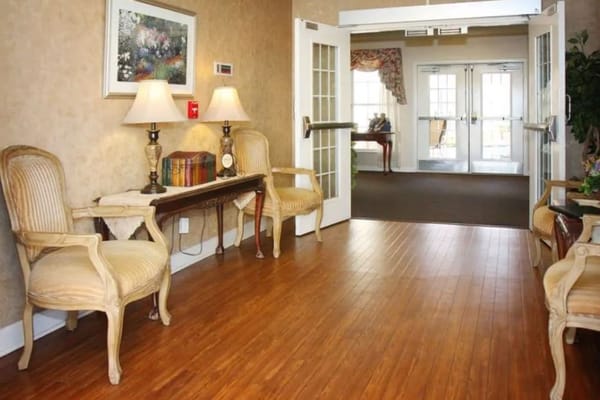Entrance hallway with chairs, lamps, and decorative elements