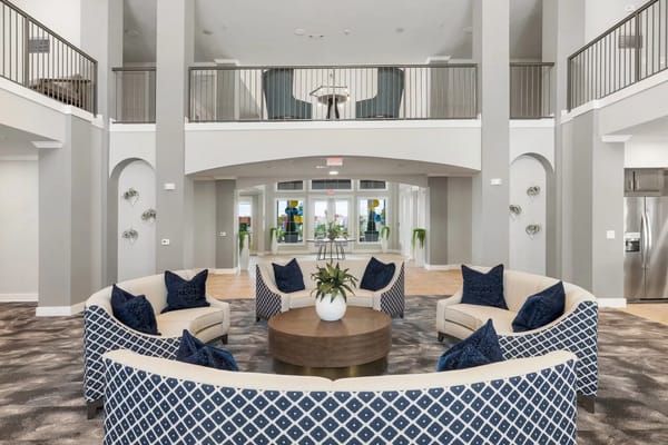 Seating area with plush sofas and a round coffee table in the lobby