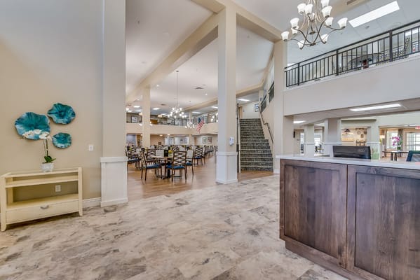 Bright common area with dining space and large staircase
