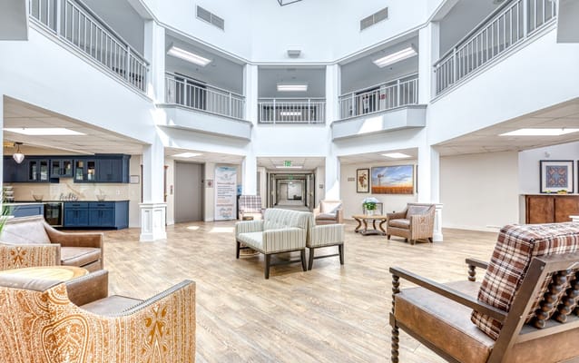 Spacious lobby with seating and a reception area at Solstice Senior Living at Plano