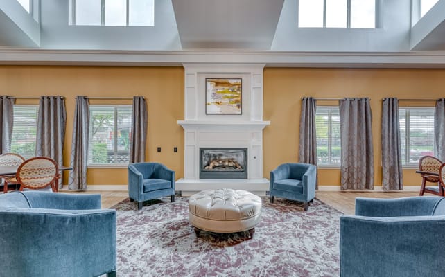 Stylish living room with blue chairs and a fireplace