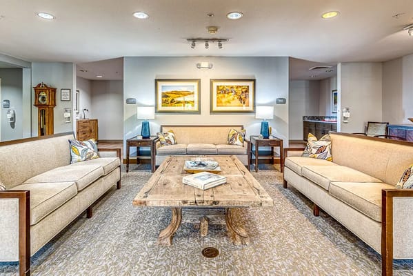 Inviting living room with sofas, coffee table, and artwork