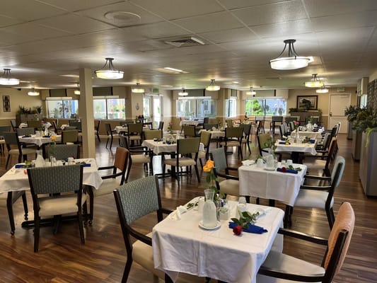 Dining room setup with tables and floral decorations