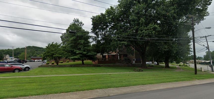 Well-maintained outdoor space with trees and grassy areas