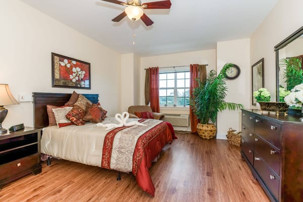 Well-decorated bedroom with a bed, pillows, and a view
