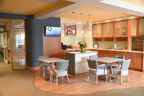 Bright common area with seating and kitchen