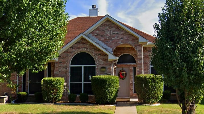 Exterior view of Sophya's Assisted Living facility with landscaped shrubs