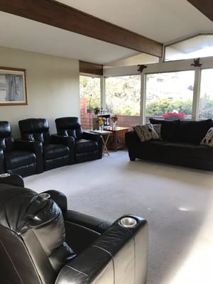 Lounge area with black leather chairs and couch