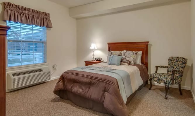 Comfortable bedroom with a bed, lamp, and chair