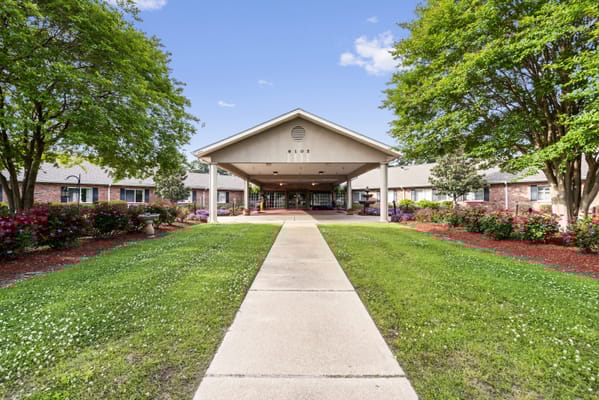 Pathway leading to the entrance of Southern Hills Healthcare and Rehabilitation surrounded by greenery and flowers