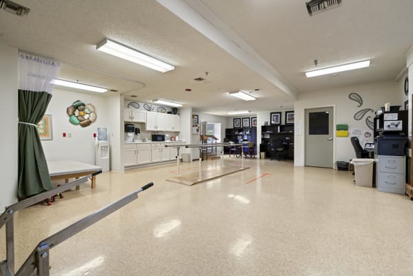 Interior view of a therapy room with equipment and seating