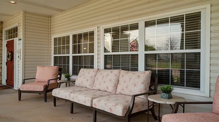 Cozy outdoor seating area with pink chairs and a small table