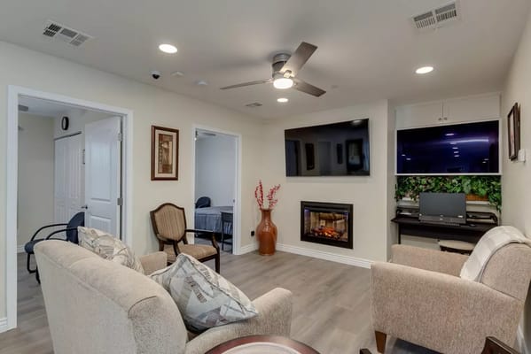 Cozy living room area with comfortable seating and electric fireplace