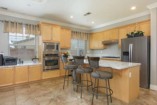 Modern kitchen with bar stools and appliances