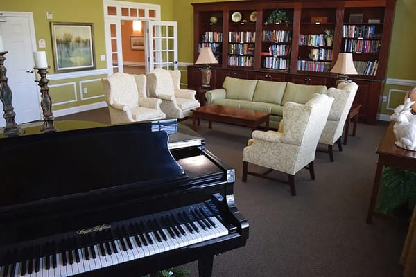 Cozy common area with seating and bookshelf