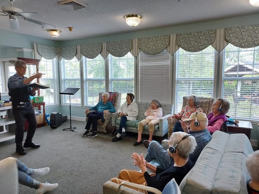 Residents enjoying a music activity in a bright common area