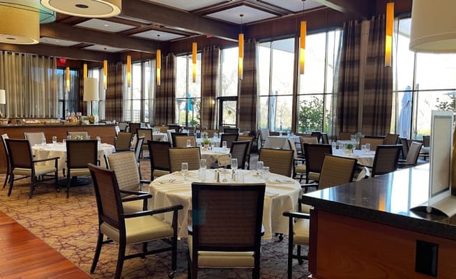 Elegant dining room with round tables and large windows