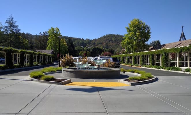 Fountain surrounded by landscaped gardens at the entrance of Spring Lake Village